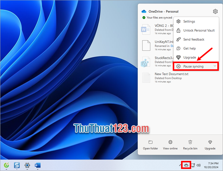 Nhấn chuột phải vào biểu tượng OneDrive trên thanh taskbar và chọn Pause syncing